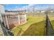 A well-maintained backyard featuring a brown deck, a view of a serene pond, and a chain-link fence at 10708 Inspiration Dr, Indianapolis, IN 46259