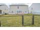 Large backyard with a deck, fire pit, and fence, perfect for outdoor entertaining and relaxation at 10708 Inspiration Dr, Indianapolis, IN 46259