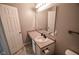 Neutral bathroom with a vanity, mirror, modern fixtures, and clean, white door at 10708 Inspiration Dr, Indianapolis, IN 46259