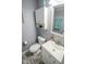 Bathroom features a vanity, mirror, commode and overhead storage at 10708 Inspiration Dr, Indianapolis, IN 46259
