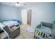 Bright Bedroom featuring a crib and comfy chair, designed for peaceful moments and sweet dreams at 10708 Inspiration Dr, Indianapolis, IN 46259