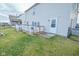 Exterior view of the home highlighting the back deck, well-kept yard, and access door at 10708 Inspiration Dr, Indianapolis, IN 46259