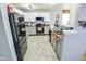 A modern kitchen with stainless steel appliances, white cabinets, and a view of the sink area at 10708 Inspiration Dr, Indianapolis, IN 46259