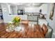 Open concept kitchen with white cabinets, eat-in kitchen table and decorative flower arrangements at 10708 Inspiration Dr, Indianapolis, IN 46259
