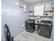 Well-organized laundry room with modern washer and dryer, featuring stylish decor and ample storage at 10708 Inspiration Dr, Indianapolis, IN 46259