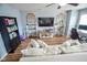 Open living room featuring shelving units, hardwood floors, and a comfortable couch at 10708 Inspiration Dr, Indianapolis, IN 46259