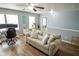 Living room showing the ceiling fan, sofa with pillows, and a view to the hallway at 10708 Inspiration Dr, Indianapolis, IN 46259