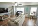 Cozy living room featuring a ceiling fan, hardwood floors, and an entertainment center at 10708 Inspiration Dr, Indianapolis, IN 46259