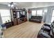 An open-concept living room featuring recessed lighting, laminated wood flooring, and oversized furniture at 10708 Inspiration Dr, Indianapolis, IN 46259