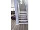 Stairway featuring carpet runners and white banister at 10708 Inspiration Dr, Indianapolis, IN 46259