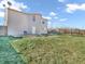 A spacious backyard offers a deck, green lawn, and fenced perimeter for privacy at 10830 Clear Spring Dr, Camby, IN 46113