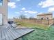 Backyard showcasing a wood deck with a grill, a grassy lawn, and a wood fence at 10830 Clear Spring Dr, Camby, IN 46113