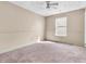 A neutral bedroom offers a ceiling fan and ample natural light through the window at 10830 Clear Spring Dr, Camby, IN 46113