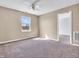 A cozy bedroom with carpet, a ceiling fan, and a window for natural light at 10830 Clear Spring Dr, Camby, IN 46113