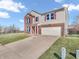 Traditional two-story home with red shutters, brick accents, and attached two-car garage at 10830 Clear Spring Dr, Camby, IN 46113