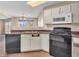 This kitchen has white cabinets, updated appliances, and a window over the sink at 10830 Clear Spring Dr, Camby, IN 46113