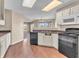 The kitchen features black appliances, white cabinets, and a large sink at 10830 Clear Spring Dr, Camby, IN 46113