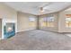 Inviting living room featuring neutral colors, fireplace, ceiling fan and plush carpeting at 10830 Clear Spring Dr, Camby, IN 46113