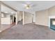 Open-concept living room with carpet, fireplace, and easy access to the stairs and other living areas at 10830 Clear Spring Dr, Camby, IN 46113