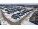 Aerial view of a residential neighborhood with houses, streets, and cul-de-sacs in a snowy landscape at 10865 Mystic View Ct, Indianapolis, IN 46239