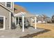 This back patio offers outdoor dining beneath a charming white pergola, ideal for enjoying the fresh air and neighborhood views at 10865 Mystic View Ct, Indianapolis, IN 46239