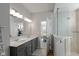 Bathroom with double sink vanity and a walk-in shower with glass door at 10865 Mystic View Ct, Indianapolis, IN 46239