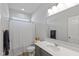 Clean bathroom featuring a shower with a curtain, toilet, and a grey vanity at 10865 Mystic View Ct, Indianapolis, IN 46239