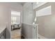 Modern bathroom featuring glass shower and a glimpse into the bedroom space at 10865 Mystic View Ct, Indianapolis, IN 46239