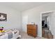 Comfortable bedroom with a bed, wooden dresser, and doorway at 10865 Mystic View Ct, Indianapolis, IN 46239