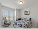 Well-lit bedroom with rocking chair, window and comfortable furnishings at 10865 Mystic View Ct, Indianapolis, IN 46239