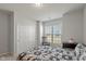 Bright bedroom featuring a window, rocking chair and closet with bi-fold doors at 10865 Mystic View Ct, Indianapolis, IN 46239