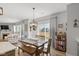 Bright dining area with a wooden table set, a pendant light fixture and sliding glass doors to the outside at 10865 Mystic View Ct, Indianapolis, IN 46239