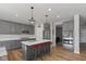 Modern kitchen with stainless steel appliances, island seating, and bright recessed lighting at 10865 Mystic View Ct, Indianapolis, IN 46239