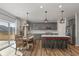 Stylish kitchen featuring a large island, stainless steel appliances, and dining space at 10865 Mystic View Ct, Indianapolis, IN 46239