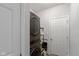 A well-organized laundry room with a stacked washer/dryer set and a storage shelf at 10865 Mystic View Ct, Indianapolis, IN 46239