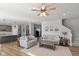 Open-concept living room with hardwood floors, gray walls, fireplace and lots of natural light at 10865 Mystic View Ct, Indianapolis, IN 46239