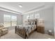 Comfortable main bedroom with a tray ceiling, a large window and neutral decor at 10865 Mystic View Ct, Indianapolis, IN 46239