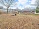 Residential backyard with a brick house, a metal barrel, and a wooden fence surround at 12386 S Hillview Dr, Columbus, IN 47201