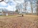 Large backyard with leafless ground cover and wooden fence in residential neighborhood at 12386 S Hillview Dr, Columbus, IN 47201