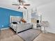Bright bedroom featuring a large bed with silver frame, a full length mirror and a ceiling fan at 12386 S Hillview Dr, Columbus, IN 47201