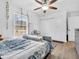 Bedroom features a large window with hanging vines and a neutral color palette with wood flooring at 12386 S Hillview Dr, Columbus, IN 47201