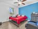 Bedroom with a full-size bed, blue accent wall, and a bright window view at 12386 S Hillview Dr, Columbus, IN 47201