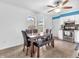 Dining area adjoining kitchen, featuring a wooden table and neutral decor at 12386 S Hillview Dr, Columbus, IN 47201