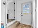 Entryway with view of back yard through a windowed door with tile and vinyl flooring at 12386 S Hillview Dr, Columbus, IN 47201