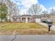 Charming brick home with manicured lawn, double hung windows and an attached garage at 12386 S Hillview Dr, Columbus, IN 47201