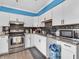 Modern kitchen featuring stainless steel appliances, subway tile backsplash, and white cabinetry at 12386 S Hillview Dr, Columbus, IN 47201