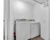 Functional laundry room with a white washer and dryer set with access to storage at 12386 S Hillview Dr, Columbus, IN 47201