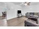 Bright living room featuring hardwood floors, a ceiling fan, and comfortable seating area at 12386 S Hillview Dr, Columbus, IN 47201