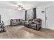 Spacious living area with natural light, ceiling fan, hardwood floors, and cozy seating arrangement at 12386 S Hillview Dr, Columbus, IN 47201