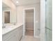 Elegant bathroom with double sinks, quartz countertop, and a glass-enclosed shower, plus walk-in closet access at 1257 Newton St, Avon, IN 46123